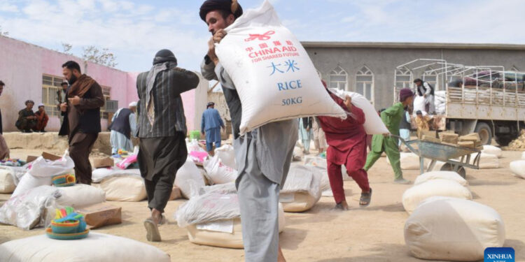 Afghan people carry China-donated relief supplies in Jawzjan province, Afghanistan, Aug. 24, 2022. Photo:Xinhua