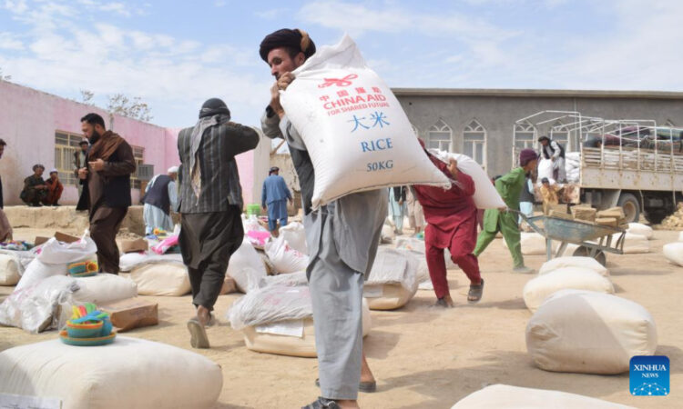 Afghan people carry China-donated relief supplies in Jawzjan province, Afghanistan, Aug. 24, 2022. Photo:Xinhua