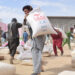 Afghan people carry China-donated relief supplies in Jawzjan province, Afghanistan, Aug. 24, 2022. Photo:Xinhua