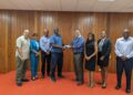 Vice-President Philip Fernandes in centre hands over sponsorship cheque to Mr. Terrence Poole, Technical Director of the Guyana Amateur Boxing Association flanked by Executive Members of the Guyana Olympic Association. From left to right: Mr. Michael Singh, Ms. Emily Ramdhani, Mr. Godfrey Munroe, Mr. Terrence Poole, Mr. Philip Pernandes, Ms. Vidushi Persaud-McKinnon, Ms. Cristy Campbell and Mr. Steve Ninvalle.