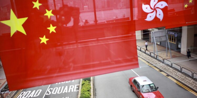 China's national flag and the flag of the Hong Kong Special Administrative Region are hung over the street for the celebration of 24th anniversary of Hong Kong's return to the motherland at Tsim Sha Tsui East in Hong Kong on June 29, 2021. [Photo by Edmond Tang/chinadaily.com.cn]