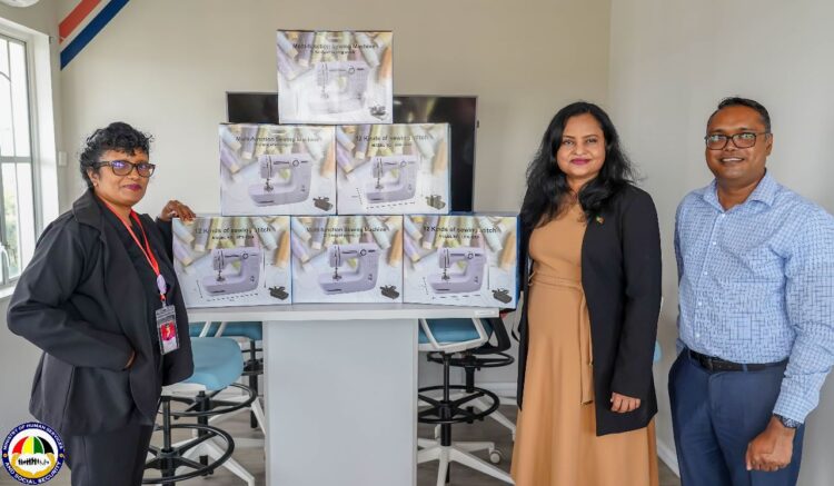 Minister of Human Services and Social Security, Honorable Dr. Vindhya Persaud (center) along with WIIN coordinator, Sanjay Pooran receives over 100 sewing machines from Silvie’s Industrial Solutions’ Deepawattie Persaud