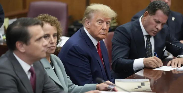 Former President Donald Trump sits at the defense table with his defense team in a Manhattan court, Tuesday, April 4, 2023, in New York. Trump is set to appear in a New York City courtroom on charges related to falsifying business records in a hush money investigation, the first president ever to be charged with a crime.
