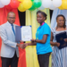  Lenisha receiving her IYRC certificate from a Tullow Oil Rep at STEMGuyana’s 2022 Award Ceremony.