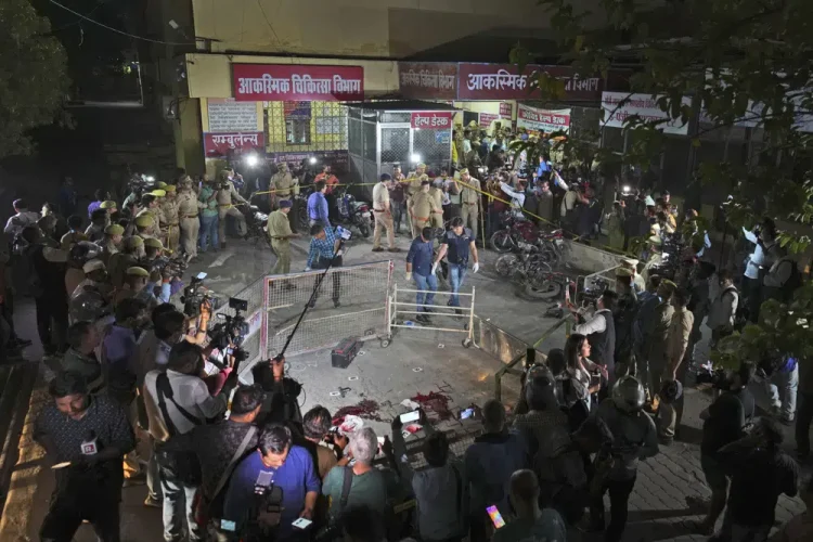 Police and media surround the area where Gangster-turned-politician Atiq Ahmad and his brother Ashraf were shot in front of the Motilal Nehru medical college in, Prayagraj, India, Saturday, April 15, 2023. Jailed gangster-turned-politician Atiq Ahmad and his brother Ashraf were shot dead by unidentified assailants while they were being escorted by police to a medical college here on Saturday night, according to the Indian news agency Press Trust of India. (AP Photo/Rajesh Kumar Singh)