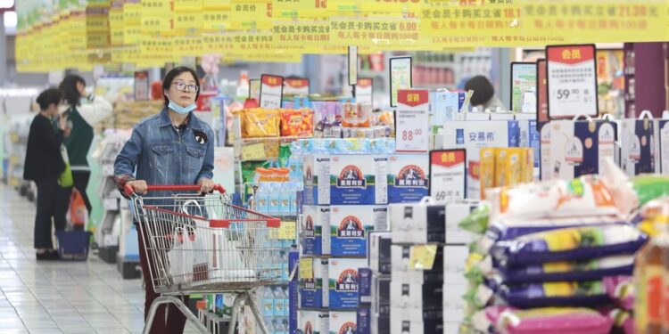 People shop at a supermarket in Nanjing, east China's Jiangsu Province, April 11, 2023. (Photo by Su Yang/Xinhua)