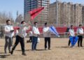 Students from the aviation model association of Harbin Institute of Technology launch a model airplane on campus in Harbin, capital of northeast China's Heilongjiang Province, on April 22 (XINHUA)
