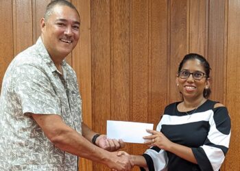 Secretary-General of the Guyana Olympic Association, Mrs. Vidushi Persaud-McKinnon hands over sponsorship cheque to Mr. David Fernandes, President of the Guyana Squash Association.