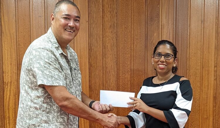 Secretary-General of the Guyana Olympic Association, Mrs. Vidushi Persaud-McKinnon hands over sponsorship cheque to Mr. David Fernandes, President of the Guyana Squash Association.