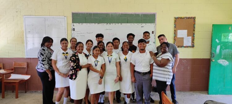 Zeeburg Secondary School’s acting Head of Department for Business, Ms Anella Bissessar with the students at the Belmopan Comprehensive High School