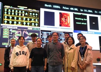 Researchers pose for a group photo after the success of an experiment at the control center of the experimental advanced superconducting tokamak (EAST) in Hefei, east China's Anhui Province, on April 12 (XINHUA)