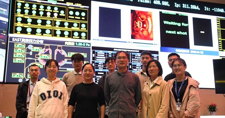 Researchers pose for a group photo after the success of an experiment at the control center of the experimental advanced superconducting tokamak (EAST) in Hefei, east China's Anhui Province, on April 12 (XINHUA)
