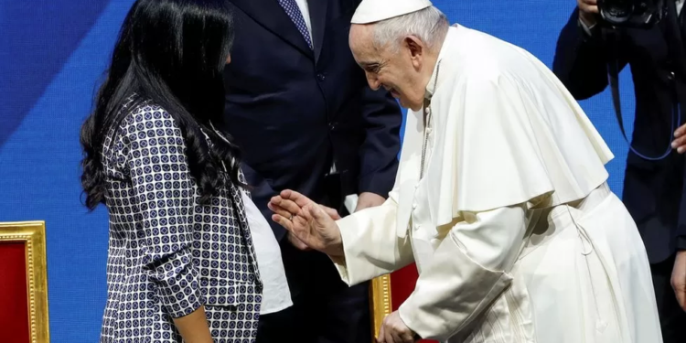 Pope Francis blesses a pregnant woman at the national conference looking at Italy's demographics
