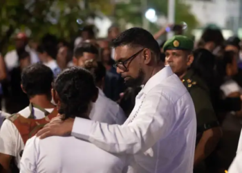 President Irfaan Ali interacting with a grieving family member during the national vigil