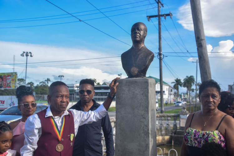 Michael 'Mike' Parris and family standing next to his bust which was unveiled on May 18.
(SN photo)