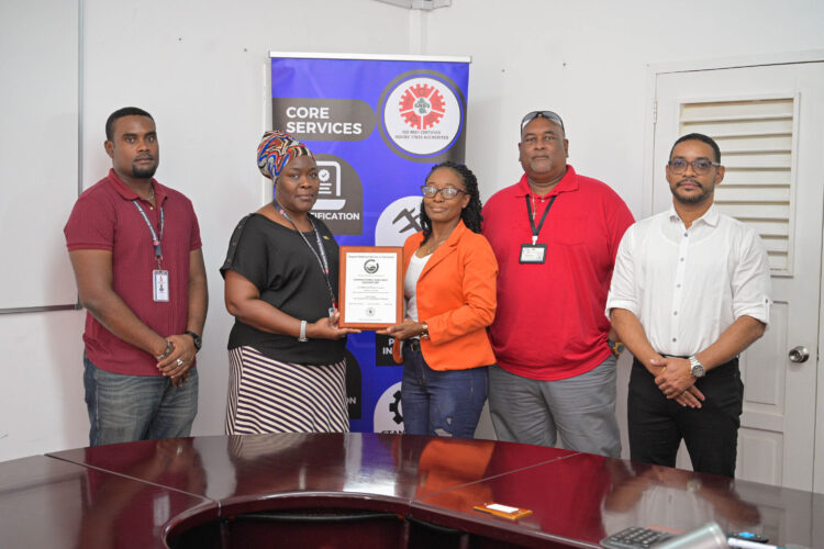 GPL Senior Manager for HSE & Laboratory Services, Ms. Denise Griffith receives GNBS Plaque from GNBS Technical Officer, Ms. Charissa Wilson. Also in photo are GNBS Technical Officer, Mr. Keon Rankin (left), Quality Manager, Mr. Nigel Chetram (centre) and Divisional Director, Mr. Gary Hall (right)