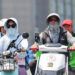 Passengers wear sun-protective clothing in Beijing, June 23, 2023. /CFP