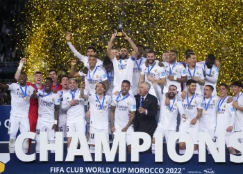 FILE - Real Madrid players celebrate with the trophy after winning the FIFA Club World Cup final match against Al Hilal at Prince Moulay Abdellah stadium in Rabat, Morocco, Saturday, Feb. 11, 2023. The United States will host the Club World Cup in 2025, the first time the FIFA tournament will have 32 teams. Real Madrid, Manchester City and Chelsea already earned places as recent Champions League winners for the expanded tournament lineup that is set to test stadiums and operations one year before the 2026 World Cup. (AP Photo/Manu Fernandez, File)
