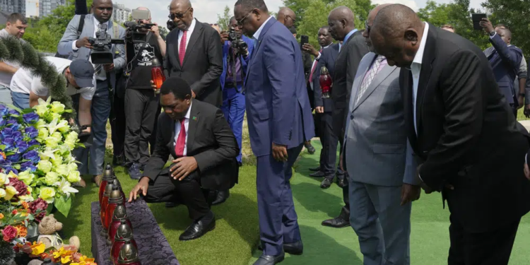 From right, South African President Cyril Ramaphosa, President of the Union of Comoros Azali Assoumani, Senegal's President Macky Sall, and Zambia's President Hakainde Hichilema, bottom, attend a commemoration ceremony at a site of a mass grave in Bucha, on the outskirts of Kyiv, Ukraine, Friday, June 16, 2023. South African President Cyril Ramaphosa arrived in Ukraine on Friday as part of a delegation of African leaders and senior officials seeking ways to end Kyiv's 15-month war with Russia. (AP Photo/Efrem Lukatsky).