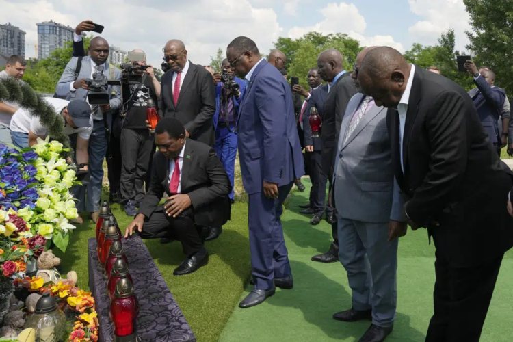 From right, South African President Cyril Ramaphosa, President of the Union of Comoros Azali Assoumani, Senegal's President Macky Sall, and Zambia's President Hakainde Hichilema, bottom, attend a commemoration ceremony at a site of a mass grave in Bucha, on the outskirts of Kyiv, Ukraine, Friday, June 16, 2023. South African President Cyril Ramaphosa arrived in Ukraine on Friday as part of a delegation of African leaders and senior officials seeking ways to end Kyiv's 15-month war with Russia. (AP Photo/Efrem Lukatsky).