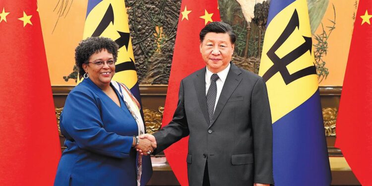 President Xi Jinping shakes hands with Prime Minister of Barbados Mia Amor Mottley at the Great Hall of the People in Beijing on Tuesday. PHOTO BY WANG ZHUANGFEI / CHINA DAILY