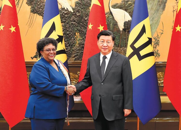 President Xi Jinping shakes hands with Prime Minister of Barbados Mia Amor Mottley at the Great Hall of the People in Beijing on Tuesday. PHOTO BY WANG ZHUANGFEI / CHINA DAILY