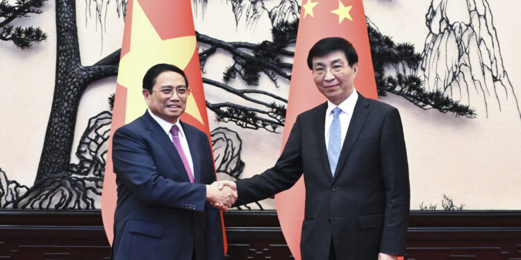 Wang Huning, chairman of the National Committee of the Chinese People's Political Consultative Conference, or CPPCC, meets Pham Minh Chinh, a member of the Political Bureau of the Central Committee of the Communist Party of Vietnam, and Prime Minister of Vietnam, in Beijing. [Photo/Xinhua]
