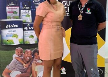 Ethan Lee receives his prize from Ms. Alicia De Abreu CEO De Sinco Ltd