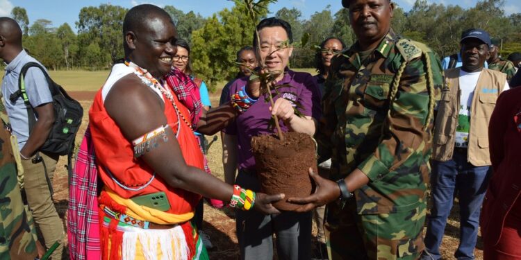 Food and Agriculture Organization of the United Nations (FAO) Director-General Qu Dongyu (C, Front) prepares to plant a medicinal seedling during a tour of Karura forest on the outskirts of Nairobi, Kenya, on Feb. 19, 2023. (Photo by Charles Onyango/Xinhua)