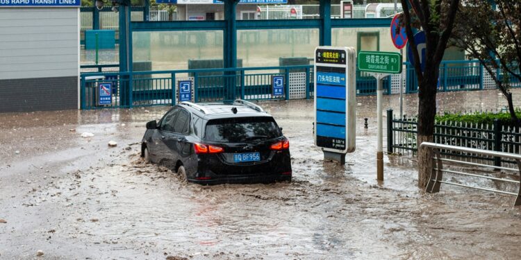 A car plows through a flooded street in Mentougou district, Beijing, on July 31, 2023. Photo: IC