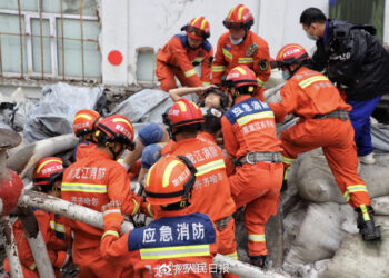 Rescuers pull out a trapped person after the roof of a gymnasium at a school in Qiqihar, Heilongjiang province, collapsed on July 23, 2023. [Photo/Weibo account of People's Daily]