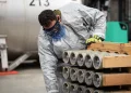 A worker removing rockets from a pallet at the Blue Grass Chemical Agent-Destruction Pilot Plant. Photo: Department of Defense.