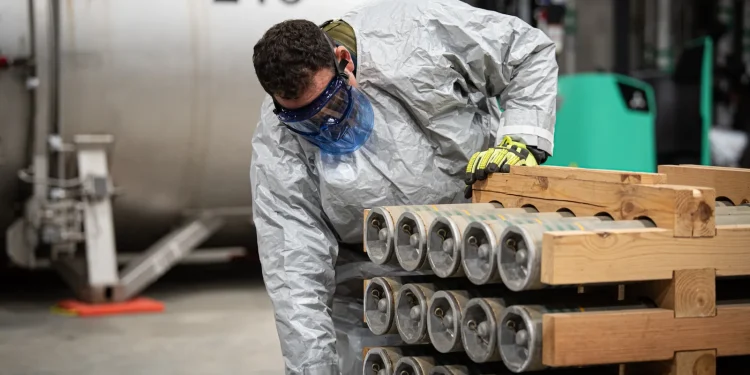 A worker removing rockets from a pallet at the Blue Grass Chemical Agent-Destruction Pilot Plant. Photo: Department of Defense.