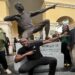 Retired sprint legend Usain Bolt strikes his iconic pose in front of his bronze sculpture at the Ansin Sports Complex in Miramar on Saturday, July 15, 2023.