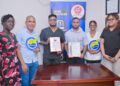 Laboratory Director of Universal Health Care Laboratory, Dr. Ravi Persaud receives GNBS Certificate from GNBS Technical Officer, Ms. Rosmarie Liliah.