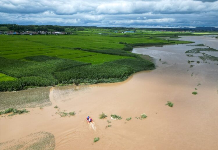This aerial photo taken on Aug. 5, 2023 shows rescuers carrying out search and rescue operations in a flood-affected area in Qili Township, Shulan City, northeast China's Jilin Province. (Xinhua/Yan Linyun)