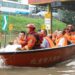 People take a rescue boat to a transshipment point in Fangshan District of Beijing, capital of China, Aug. 2, 2023. (Xinhua/Ren Chao)