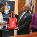 Former Principal Dale Webber (Center) presents Afua Gaisie (Left) with a token of appreciation post signing of a MOU between The UWI and the Ghana Scholarship Secretariat which will allow 25 Ghanaians the opportunity to study at The UWI Mona as Campus Registrar, Dr Donovan Stanberry (Right) smiles approvingly.