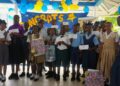 GWI CEO Shaik Baksh (sixth left); Human Resources Director, Elvis Jordon (behind Mr Baksh) and Board Director, Wendell Jeffrey (right) with the bursary awardees