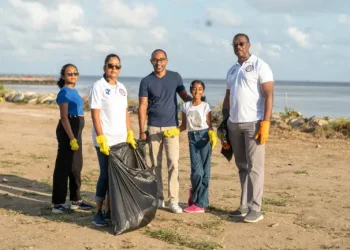 Director General of MARAD, Stephen Thomas, and a family who joined in the cleaning exercise