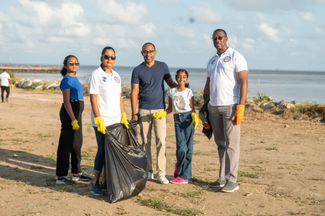 Director General of MARAD, Stephen Thomas, and a family who joined in the cleaning exercise
