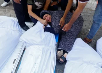 A woman mourns a loved one killed by the Israeli bombardment of Gaza, at a hospital in Gaza City, on October 11, 2023 [Reuters/Mohammed Salem]