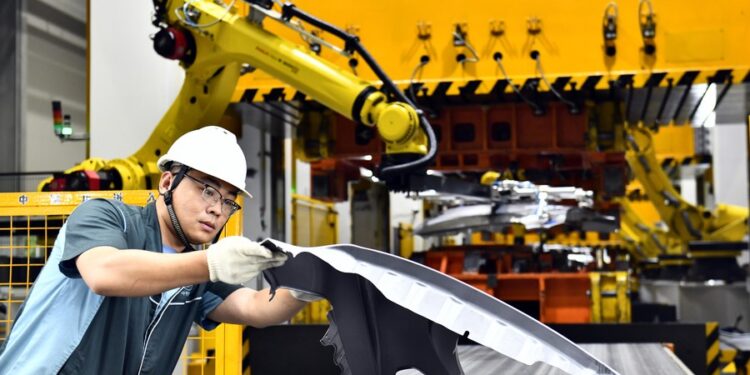 A staff member checks an auto part at carmaker ZXAUTO in Rizhao Hi-Tech Industrial Development Zone of Rizhao City, east China's Shandong Province, June 29, 2023.(Xinhua/Guo Xulei)