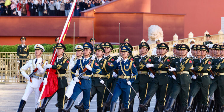 The Guard of Honor of the People's Liberation Army escorts the national flag to Tian'anmen Square in Beijing on Oct 1, 2023. [Photo by Zhu Xingxin/China Daily]