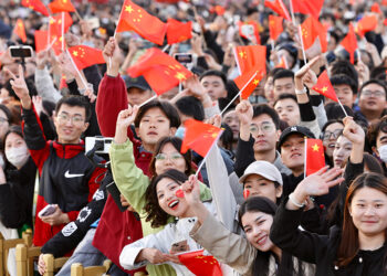 People wave national flags to celebrate the 74th anniversary of the founding of the People's Republic of China, in Tian'anmen Square in Beijing on Oct 1, 2023. [Photo by Zhu Xingxin/China Daily]