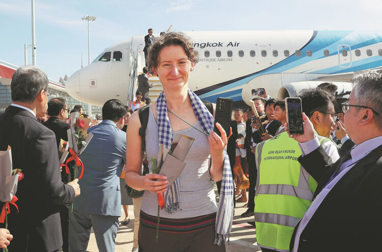 A traveler deplanes from the first passenger flight to arrive at Siem Reap-Angkor International Airport in Cambodia on Monday. [Photo by Hu Xinlin/For China Daily]