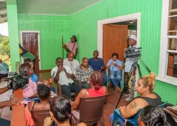 Minister McCoy addressing residents of Christianburg during a community engagement