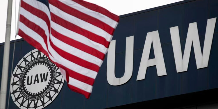 An American flag flies in front of the United Auto Workers union logo on the front of the UAW Solidarity House in Detroit, Michigan, September 8, 2011. Two years after the wrenching restructuring of the U.S. auto industry and the bankruptcies that remade General Motors and Chrysler, the UAW is facing its own financial reckoning. Picture taken September 8, 2011. To match Special Report USA-AUTOS/UNION REUTERS/Rebecca Cook (UNITED STATES - Tags: BUSINESS EMPLOYMENT TRANSPORT) Acquire Licensing Rights