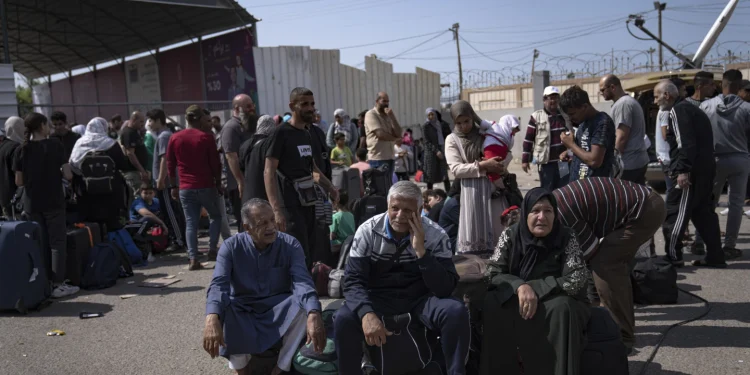 File: Palestinians wait to cross into Egypt at the Rafah border crossing in the Gaza strip, on Monday Oct. 16, 2023. As desperate Palestinians in sealed off Gaza try to find refuge under Israel's relentless bombardment in retaliation for Human's brutal Oct. 7 attack, neighboring Egypt and Jordan have replied with staunch refusal, and they have multiple reason for rejecting the idea. (AP Photo/Fatima Shbair, File)