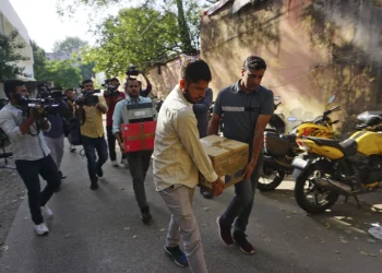 Secretary Officers carry boxes of materials confiscated after a raid at the offce in NewsClick in New Delhi India October 3, 2023